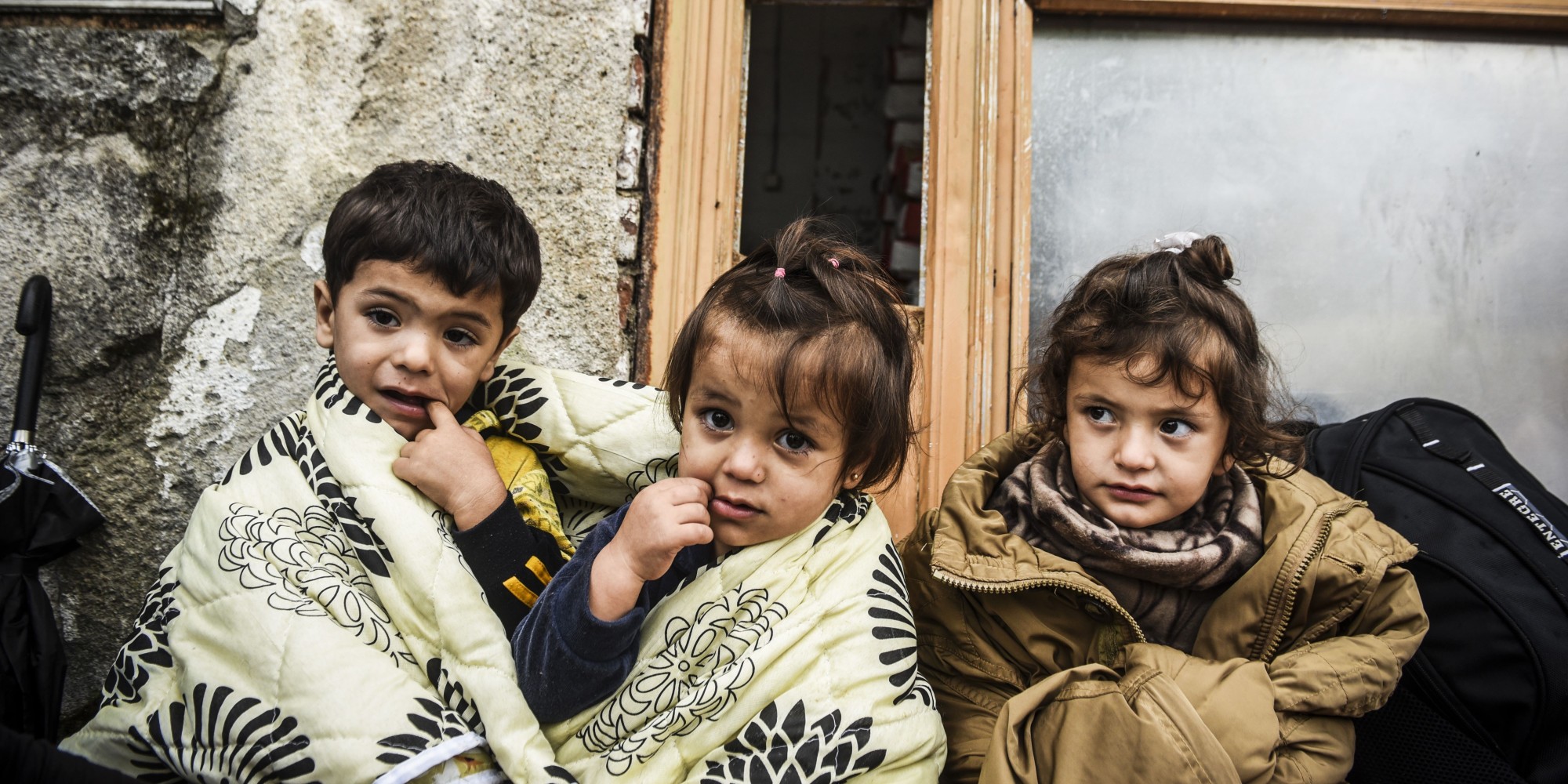 Migrants and refugee children wait near a registration camp in the southern Serbian town of Presevo on September 11, 2015. A record 5,000 migrants have arrived at Serbia's border with Hungary over the past 24 hours, a television report said on September 10. Some 3,000 of them have already entered into Hungary, the state RTS television said. Most of the migrants are moving through Hungary on their way to Germany and other northern countries where they hope to win asylum. Some 50 buses transporting around 2,500 migrants as well as three trains with around 3,000 others left on September 9 to 10 overnight from Gevgelija, on the Macedonian side of its border with Greece towards Serbia, according to AFP journalists. The EU unveiled plans to take 160,000 refugees from overstretched border states, as the United States said it would accept more Syrians to ease the pressure from the worst migration crisis since World War II. AFP PHOTO / ARMEND NIMANI        (Photo credit should read ARMEND NIMANI/AFP/Getty Images)